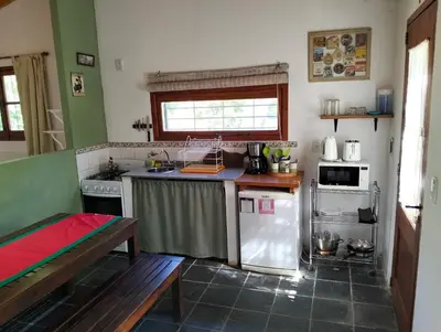 a kitchen with a refrigerator and a table in it at Casita Santa Elena N3 in Trapiche
