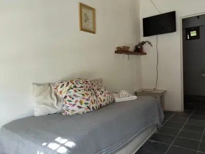 a bed with a pillow and a television in a room at Casita Santa Elena N3 in Trapiche
