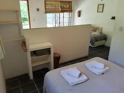a room with a bed with towels on top of it at Casita Santa Elena N3 in Trapiche