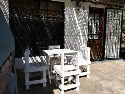 two white chairs and a table and chairs on a porch at Casita Santa Elena N3 in Trapiche