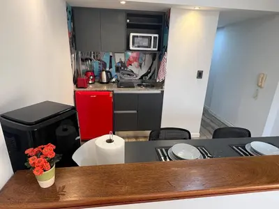 a small kitchen with a counter top in a room at VILAUT Great studio, strategic location with Pool, Gym and Coworking area in Cordoba