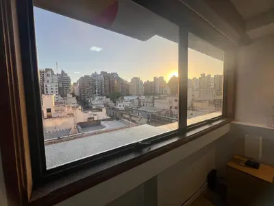 a window in a room with a view of a city at VILAUT Great studio, strategic location with Pool, Gym and Coworking area in Cordoba