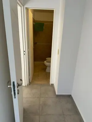 an open door to a bathroom with a toilet at Departamento Duarte Quiros 274 in Cordoba