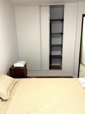 a bedroom with a bed and a mirror at Departamento Barrio General Paz in Cordoba