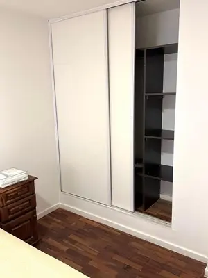 a bedroom with a closet with sliding glass doors at Departamento Barrio General Paz in Cordoba