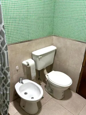 a bathroom with a toilet and a sink at Departamento Barrio General Paz in Cordoba