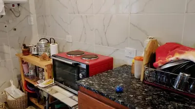 a kitchen with a red microwave on a counter at Los árboles in Potrero de Garay