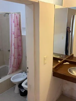 a bathroom with a sink and a toilet and a mirror at Depto Vista panoramica in Villa Carlos Paz