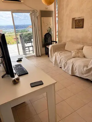 a living room with a desk with a computer on it at Depto Vista panoramica in Villa Carlos Paz