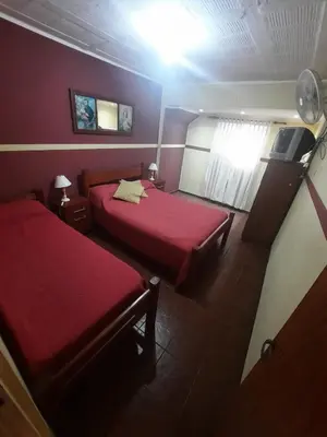 a hotel room with two beds and a window at CASA PARA 6 PERSONAS - Mis Dos Soles in Mina Clavero