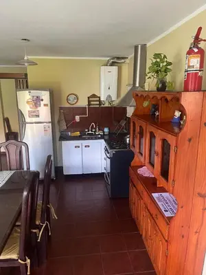 a kitchen with a white refrigerator and a stove at CASA PARA 6 PERSONAS - Mis Dos Soles in Mina Clavero
