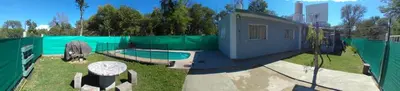 a fenced in yard with a building and a fence at La estrella Anisacate in Villa Anizacate
