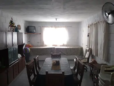 a room with a table and a bed and a window at La estrella Anisacate in Villa Anizacate