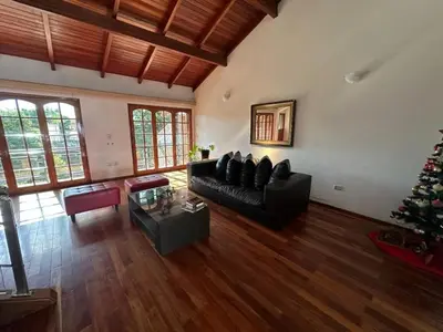 a living room with a black couch and a christmas tree at Casa en CORDOBA in Cordoba