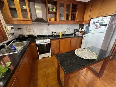a kitchen with a refrigerator and a table in it at Casa en CORDOBA in Cordoba
