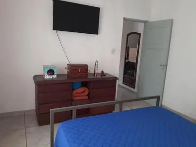 a bedroom with a bed and a dresser with a flat screen tv at Mi mirador in Bialet Massé