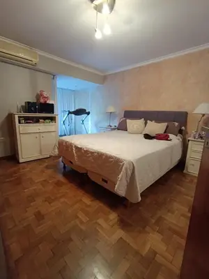 a bedroom with a large bed and a wooden floor at Bienvenidos a casa in Cordoba