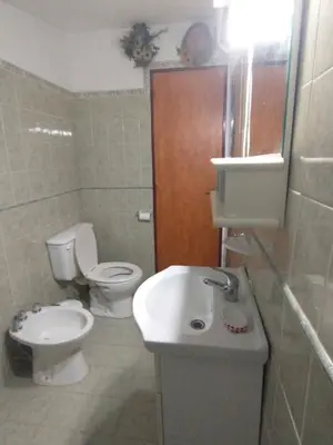 a small bathroom with a toilet and a sink at Descanso en Tanti - Turismo y Bienestar in Tanti