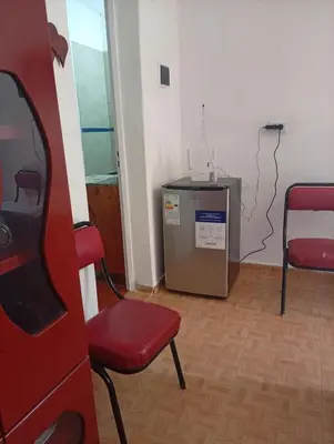 a room with a red chair and a machine at Cabañas los Materos 3 in Santa María