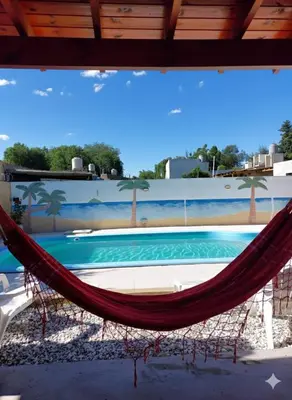 a hammock in front of a swimming pool at Cabañas los Materos 3 in Santa María
