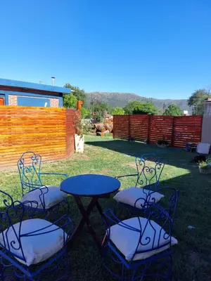 a table and four chairs in a yard at Cabañas los Materos 3 in Santa María