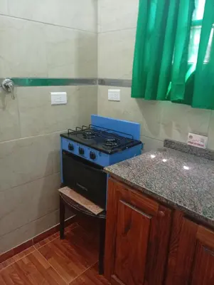 a blue stove in a kitchen with a counter at Cabañas los Materos 3 in Santa María