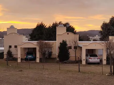 a house with two cars parked in front of it at Complejo Costa Garay in Potrero de Garay