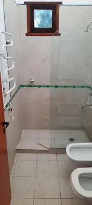 a bathroom with a shower with a toilet and a window at Complejo Costa Garay in Potrero de Garay