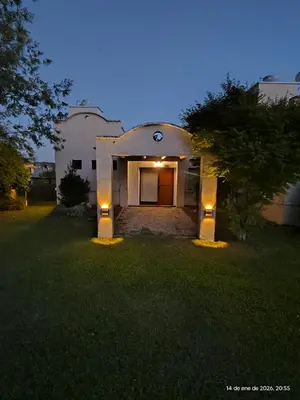 a house with lights on the front of a yard at Complejo Costa Garay in Potrero de Garay