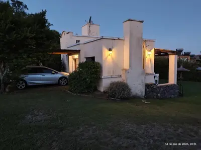 a car parked in front of a house at night at Complejo Costa Garay in Potrero de Garay