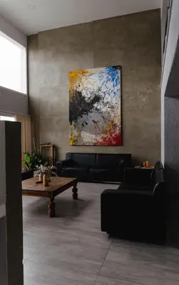 a living room with couches and a painting on the wall at Complejo Palo Blanco in Villa Carlos Paz