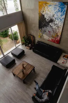 a person laying on a couch in a living room at Complejo Palo Blanco in Villa Carlos Paz