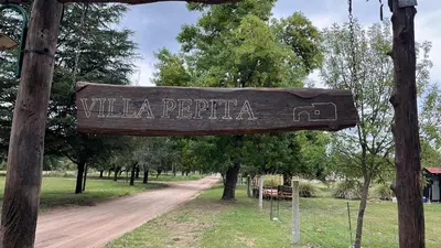 a sign that reads wilka perricula on a dirt road at Villa Pepita in Villa Quillinzo