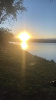 a sunset over a body of water with the sun setting at Villa Pepita in Villa Quillinzo