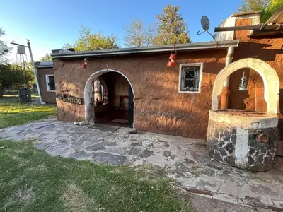 a building with an oven in a yard at Villa Pepita in Villa Quillinzo