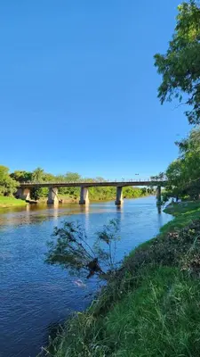 a bridge over a river with a bridge in the background at Villa Pepita in Villa Quillinzo