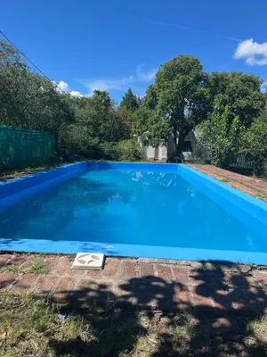a large blue swimming pool in a yard at Hospedaje San Javier in San Javier
