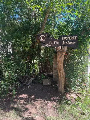 a sign for a lost pier in a forest at Hospedaje San Javier in San Javier