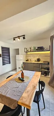 a wooden table in a room with a kitchen at LitStay - San Martin in Cordoba