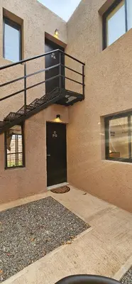 a building with a black door and a balcony at LitStay - San Martin in Cordoba