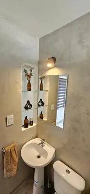a bathroom with a sink and a toilet and a mirror at LitStay - San Martin in Cordoba