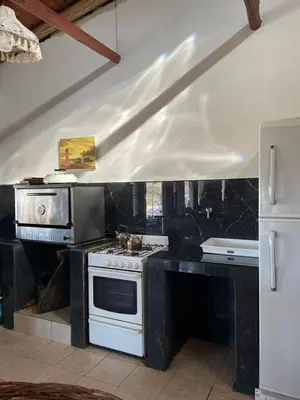 a kitchen with a white stove and a sink at La Vision, Casa de campo in Villa Quillinzo