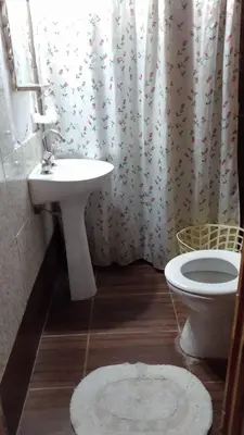 a bathroom with a sink and a toilet and a shower curtain at depto santa maria in Santa María