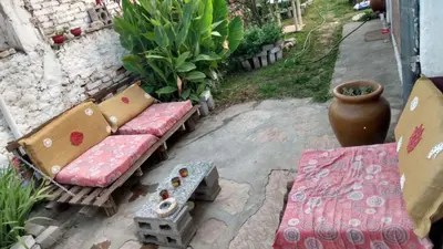 a patio with a bench and a table and a vase at depto santa maria in Santa María