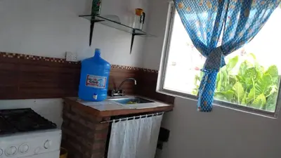 a blue bottle of water sitting on a kitchen sink at depto santa maria in Santa María