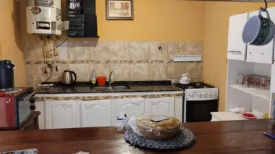 a kitchen with a counter top with a stove top oven at casa para cosquin rock in Santa María