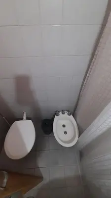 a bathroom with a toilet and a sink at Departamento en cosquin in Cosquín