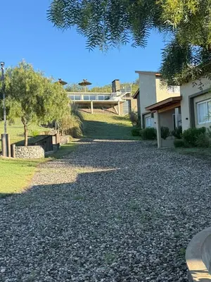 a gravel driveway in front of a house at Cabañas La casita de las sierras in Barrio Parque El Corcovado