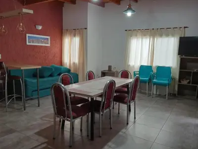 a dining room with a table and chairs at Cabañas La casita de las sierras in Barrio Parque El Corcovado