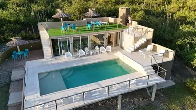 an aerial view of a house with a swimming pool at Cabañas La casita de las sierras in Barrio Parque El Corcovado